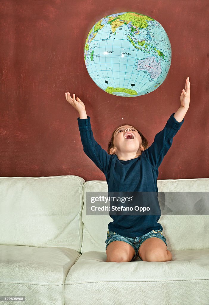 Little girl playing with the globe