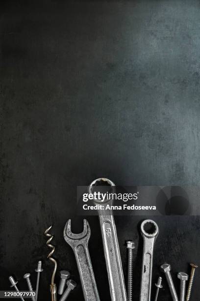 work tools in a creative composition. decorative image. wrenches and screws in the image of grass. animated objects. tools. steel tools decor. - wartezeit stock-fotos und bilder