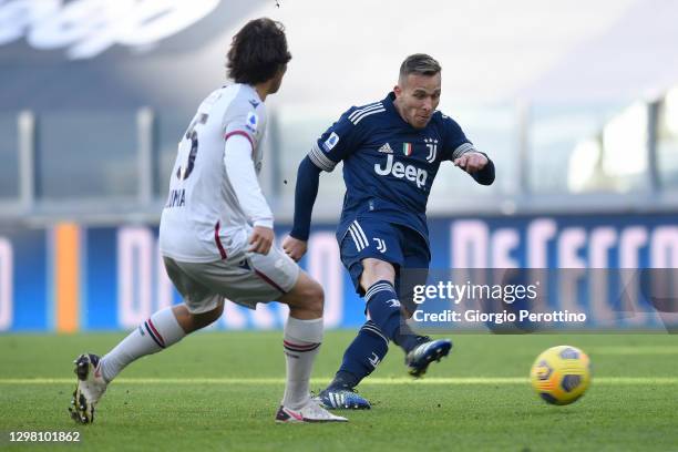 Arthur of Juventus kicks and scores his 1-0 opening goal with his teammates during the Serie A match between Juventus and Bologna FC at Allianz...