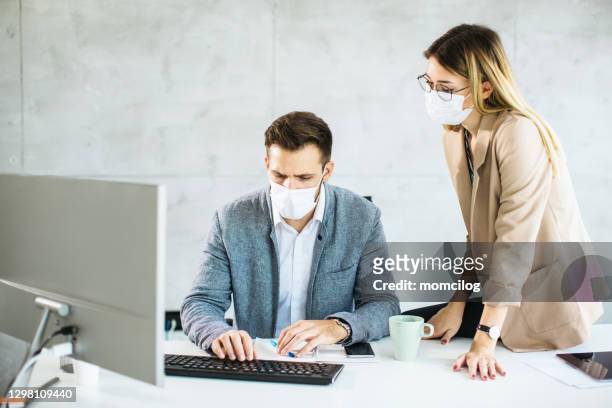 group of business people working on computer inside modern office - new business covid stock pictures, royalty-free photos & images