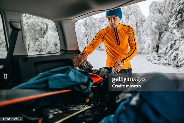 young man preparing for snowboarding - winter sport car stock pictures, royalty-free photos & images