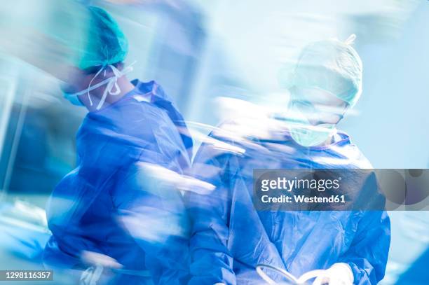 male doctors doing surgery in operating room at hospital - operating room ストックフォトと画像