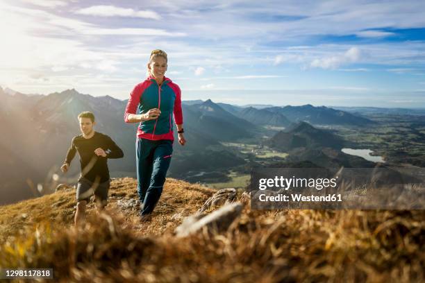 sports people practicing trail running on mountain path of saulingspitze at bavaria, germany - trailrunning stock pictures, royalty-free photos & images