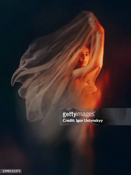 serious redhead woman covered with white silk - sheer fabric stock pictures, royalty-free photos & images