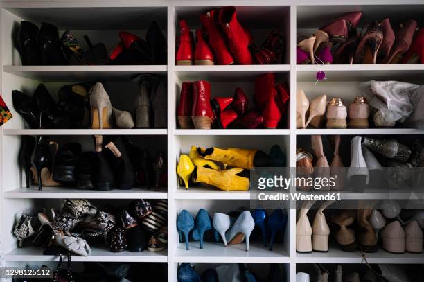 variation of footwear in rack at home - shoes closet ストックフォトと画像