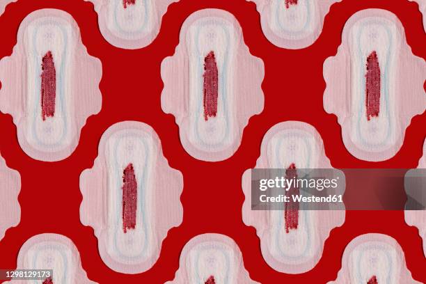 pattern of bloodstained sanitary pads against red background - period blood foto e immagini stock