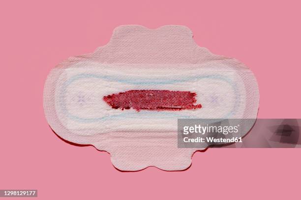 studio shot of bloodstained sanitary pad - period blood stockfoto's en -beelden