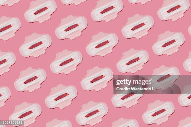 pattern of bloodstained sanitary pads against pink background - sanitary napkins stock pictures, royalty-free photos & images