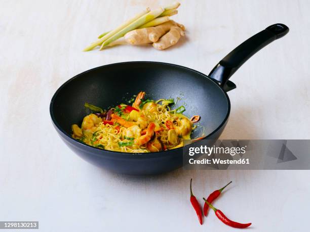 fried curry with prawns and vegetables in wok - wok ストックフォトと画像
