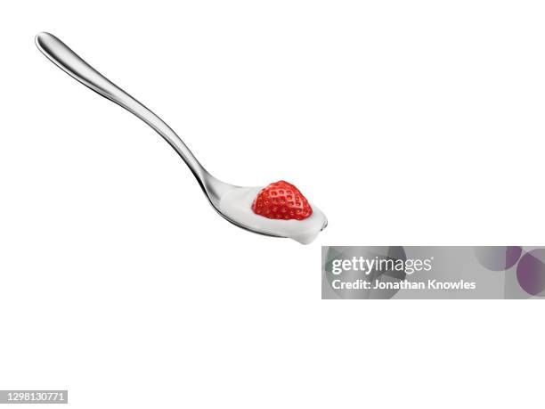 strawberry and yogurt on spoon - strawberries and cream stock pictures, royalty-free photos & images