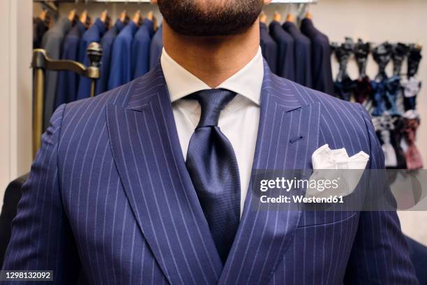 man in blue pinstripe suit in tailors boutique - striped suit stock pictures, royalty-free photos & images