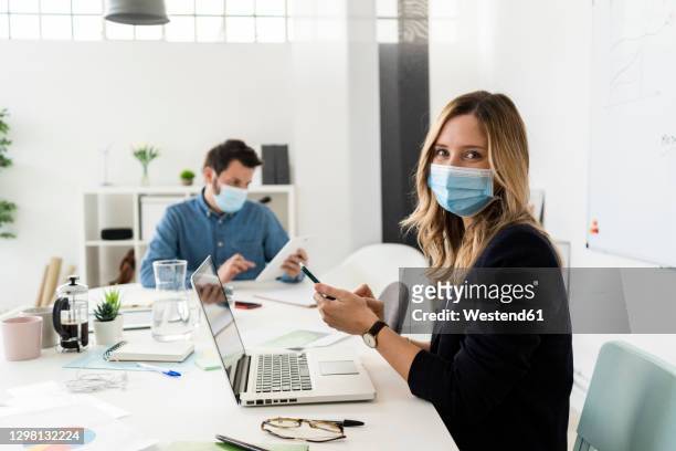 business people wearing protective masksworking in office - business meeting mask stock pictures, royalty-free photos & images