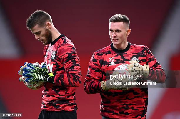 Dean Henderson of Manchester United warms up with team mate David De Gea ahead of The Emirates FA Cup Fourth Round match between Manchester United...