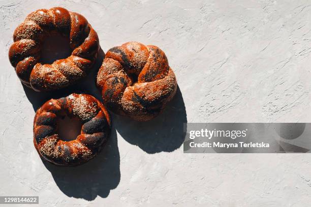 lots of baked goods with different seeds. healthy pastries. - croissant white background stock-fotos und bilder