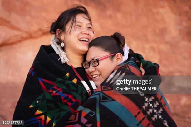 cheerful navajo sisters hugging - native american family stock pictures, royalty-free photos & images