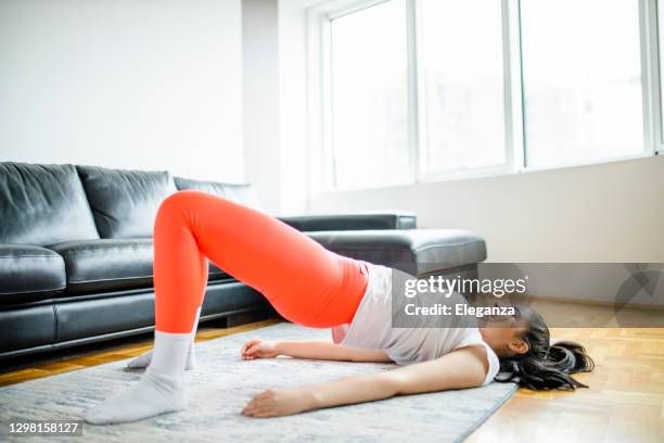 young beautiful woman having intensive home workout during pandemic of coronavirus - serbia bridge stock pictures, royalty-free photos & images