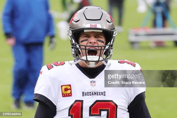 Tom Brady of the Tampa Bay Buccaneers warms up prior to their NFC Championship game against the Green Bay Packers at Lambeau Field on January 24,...