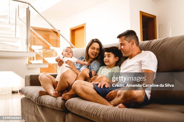 family time in the living room - tv sala stock pictures, royalty-free photos & images