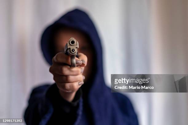 armed woman with hood - female gangster stock pictures, royalty-free photos & images