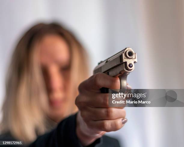 blonde girl with gun - hand holding gun stock pictures, royalty-free photos & images