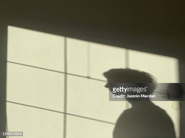 person shadow on wall - unrecognizable person stock pictures, royalty-free photos & images