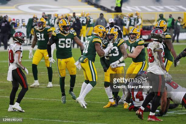 Jaire Alexander of the Green Bay Packers celebrates his interception in the fourth quarter against the Tampa Bay Buccaneers during the NFC...