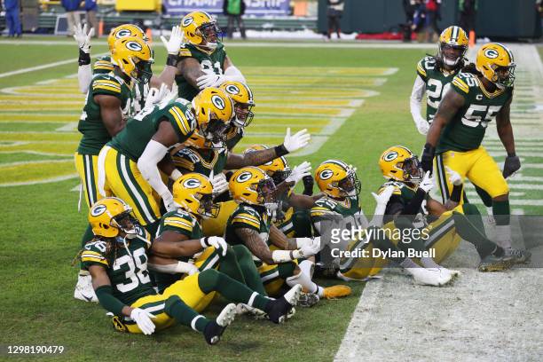 Jaire Alexander of the Green Bay Packers celebrates with teammates after his interception in the fourth quarter against the Tampa Bay Buccaneers...
