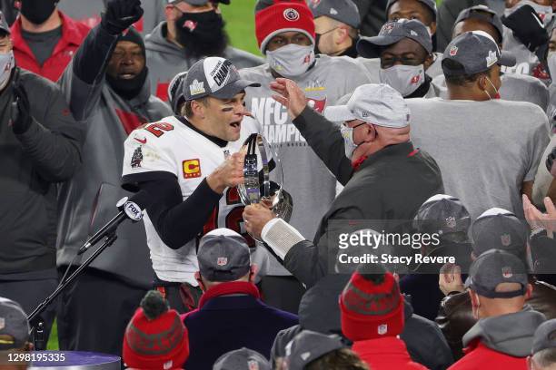 Tom Brady of the Tampa Bay Buccaneers celebrates with head coach Bruce Arians and teammates after their 31 to 26 win over the Green Bay Packers...