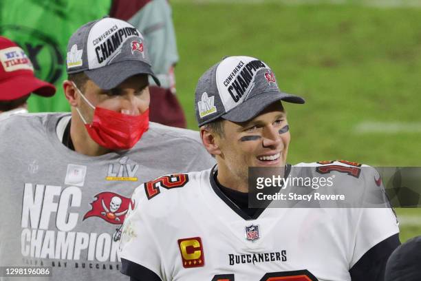 Tom Brady and Rob Gronkowski of the Tampa Bay Buccaneers celebrate their 31 to 26 win over the Green Bay Packers during the NFC Championship game at...