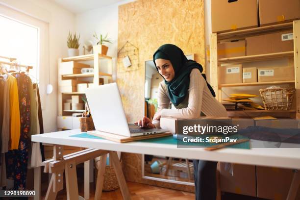 small business owner  doing e-commerce business on the laptop - hijab stock pictures, royalty-free photos & images