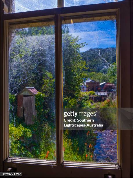 a viewpoint through a window in the quaint settlement of walhalla, a very historic gold mining village from colonial victorian times,  central gippsland, victoria. - gippsland stockfoto's en -beelden