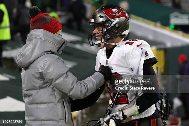 Tom Brady of the Tampa Bay Buccaneers greets his son Jack following their victory over the Green Bay Packers in the NFC Championship game at Lambeau...