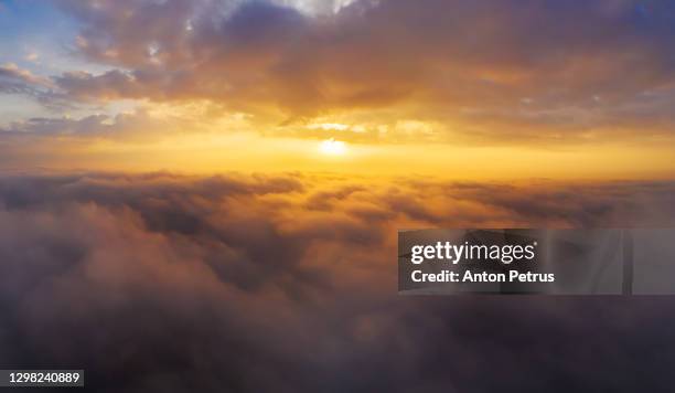 dramatic dawn above the clouds. aerial view of the clouds - above clouds stock-fotos und bilder