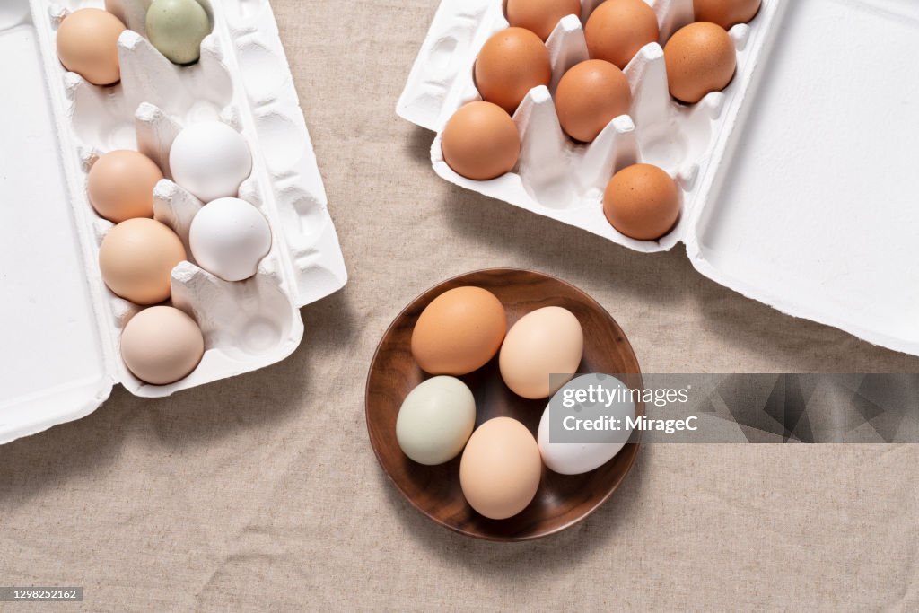 Multi Colored Chicken Eggs In Carton and Bowl