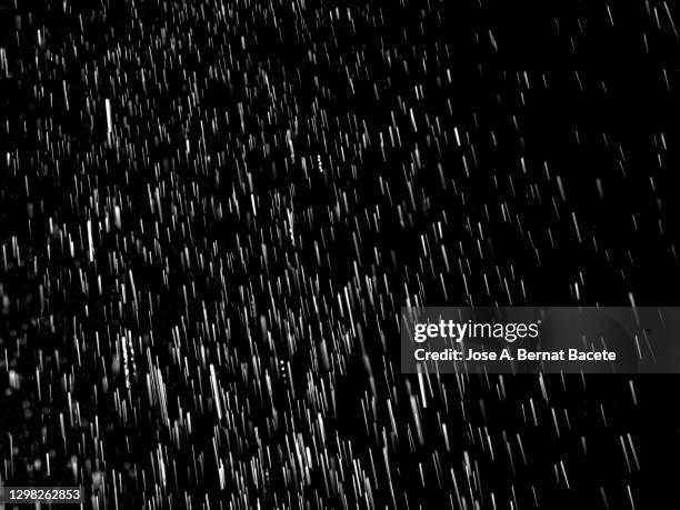 full frame of raindrops falling on a black background. - rain stock-fotos und bilder