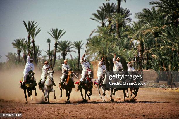 1990s The Fantasia Charge Of Horse Mounted Berber Warriors Marrakech Morocco.