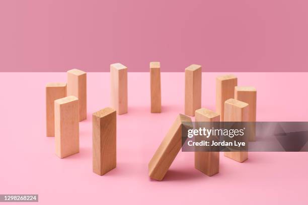 dominoes in a circle, one falling - anti gravity stock pictures, royalty-free photos & images