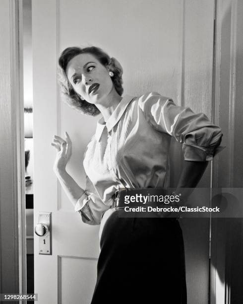 1950s Eavesdropping Curious Nosey Busybody Woman Listening For Gossip At Open Ajar Room Door.