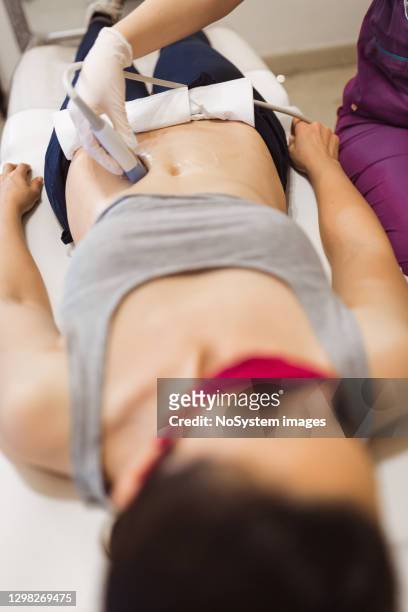 female doctor doing ultrasound examination in clinic - human reproductive organ stock pictures, royalty-free photos & images