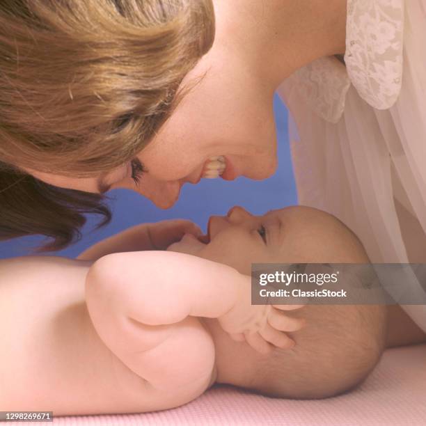 1960s Mother And Baby Facing Each Other Smiling Laughing.