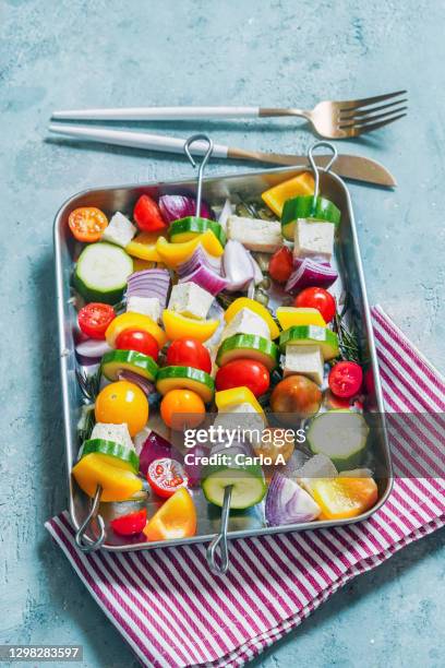 raw vegan skewers in a baking tray - feta cheese stock-fotos und bilder