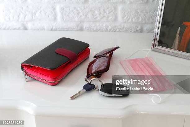 car key, wallet, car key, sanitary mask and sunglasses on table - car keys table stock pictures, royalty-free photos & images