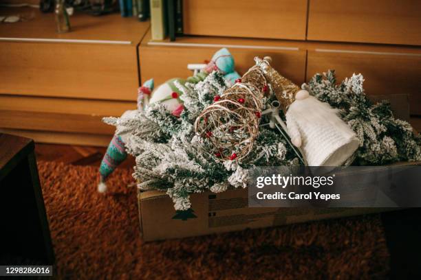packing christmas decoration in january.xmas are over - takedown stock-fotos und bilder