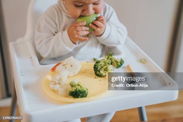 baby eating vegetables - baby eating vegetables stock pictures, royalty-free photos & images