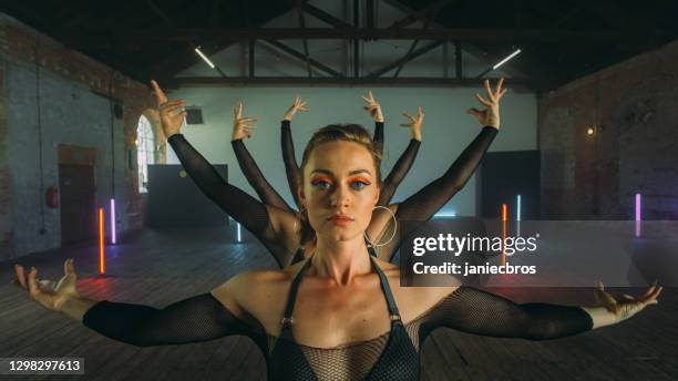 female dancers practicing in studio. dancing in a row, camo outfits - choreographer stock pictures, royalty-free photos & images