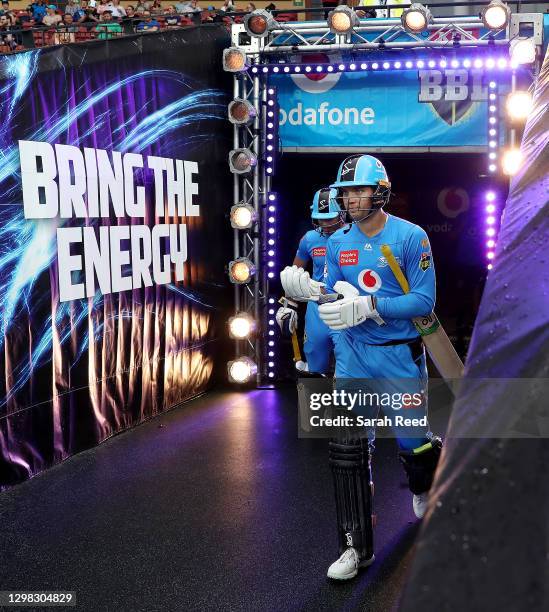 Alex Carey of the Strikers and Jake Weatherald of the Strikers walk out for the start of the Big Bash League match between the Adelaide Strikers and...