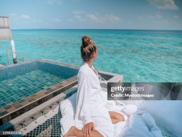 woman relaxing in luxury hotel in the maldives - maldives stock pictures, royalty-free photos & images