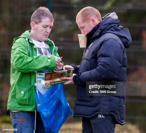 Celtic manager Neil Lennon signs his autobiography for a lucky fan