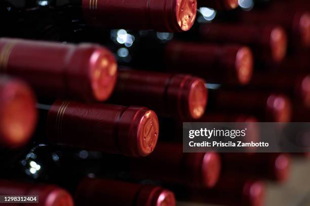 wine bottles in wine cellar - cellar stock pictures, royalty-free photos & images