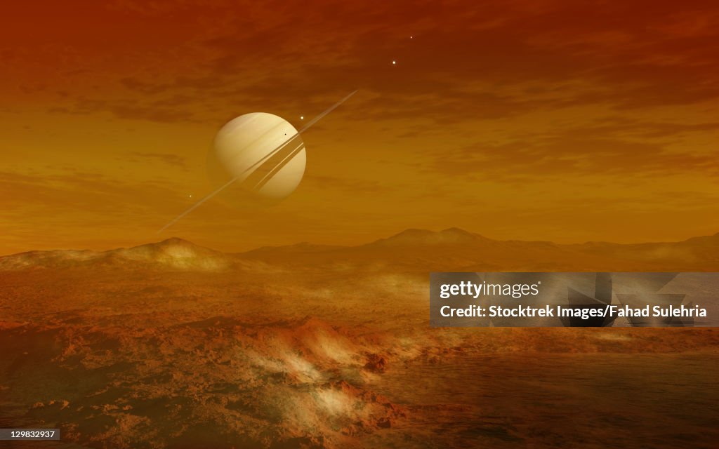Saturn above the thick atmosphere of its moon Titan.
